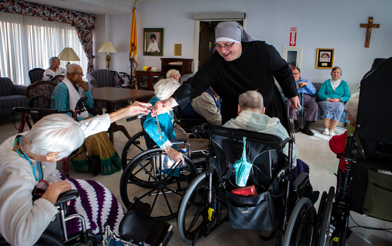 Sister Constance Veit, a Little Sister of the Poor, collects rosaries from elderly residents following prayers at the Jeanne Jugan Residence for senior care in Washington March 25, 2019. Sister Constance is considered a spiritual mother by many of the residents, who said they will honor her on Mother’s Day. (CNS photo/Chaz Muth) See MOTHERS-DAY-NUN April 26, 2019.
